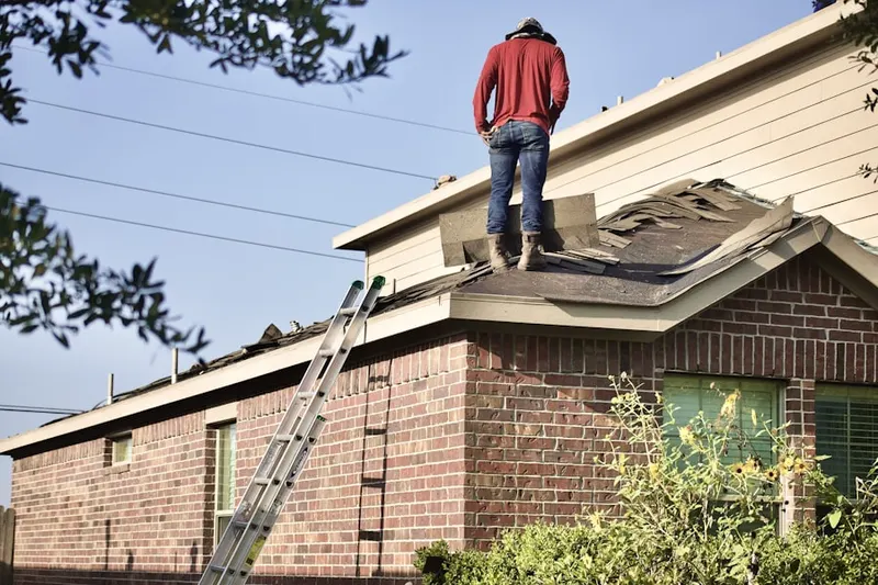 Professional roofer working on a residential roof in Tonawanda